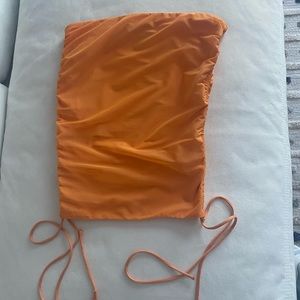 Ours— Orange tube top.